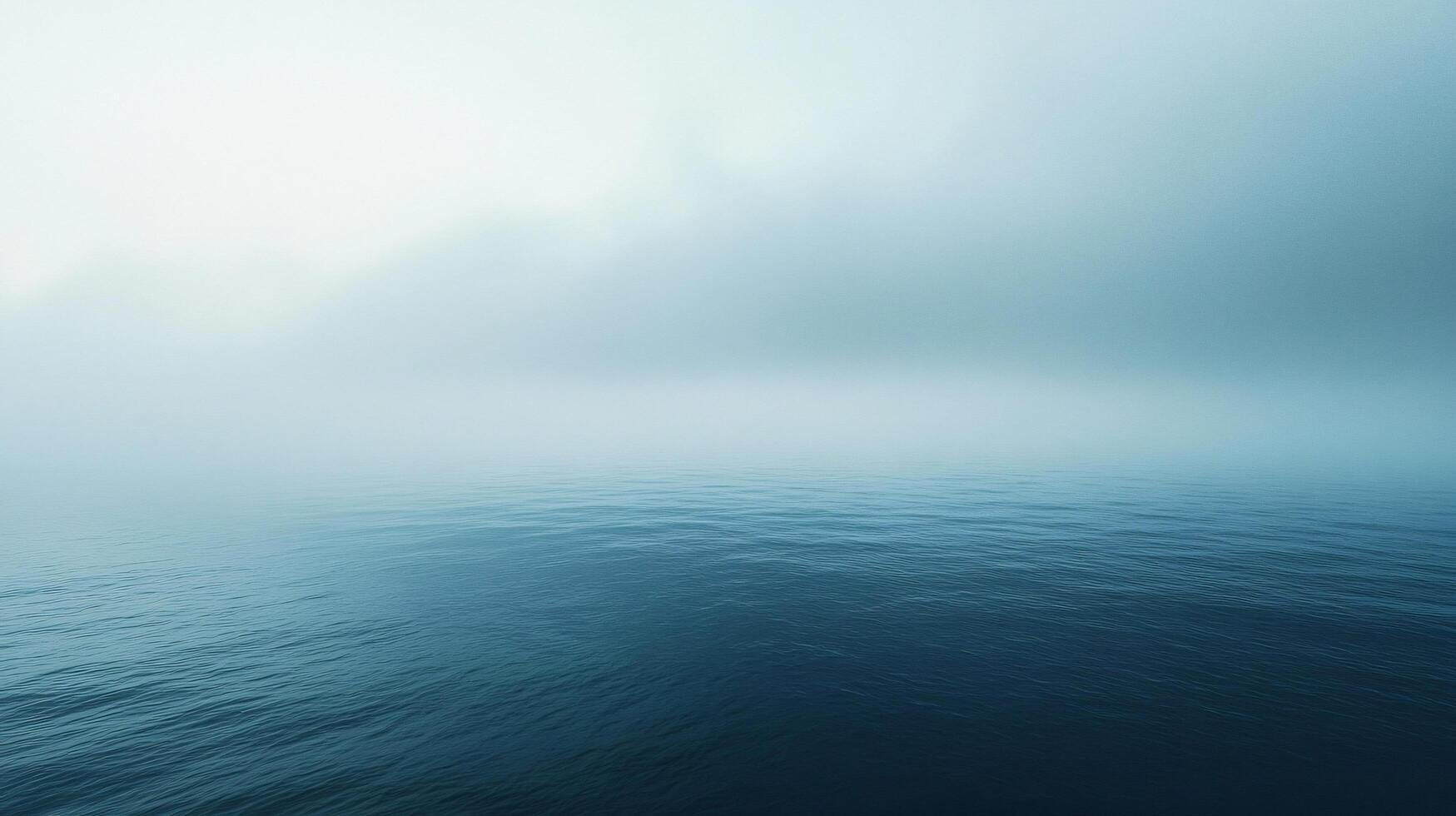 Calm ocean surface merging with fog creates a mysterious and tranquil atmosphere photo