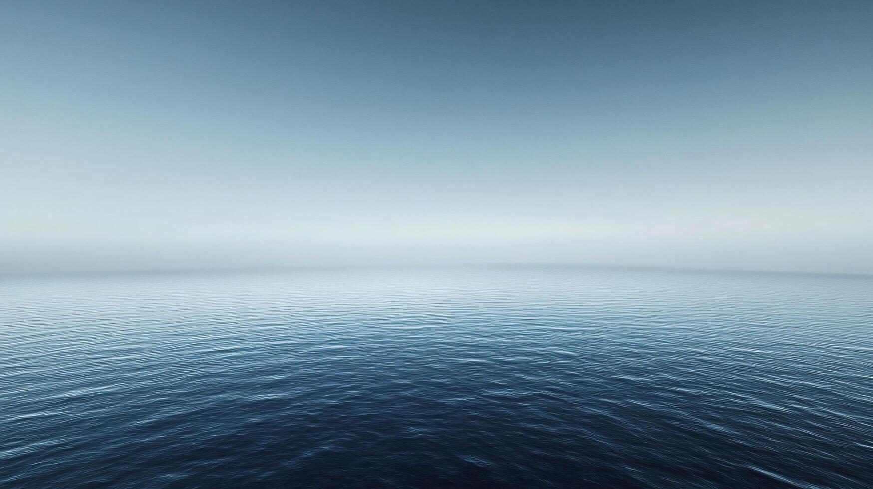Calm ocean water meets a foggy sky, creating a serene and minimalist atmosphere photo