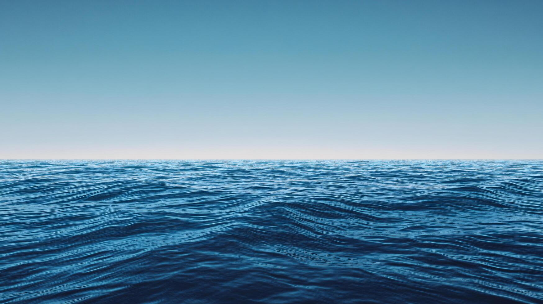 Calm ocean waves rolling under clear sky on sunny day, creating a peaceful seascape photo