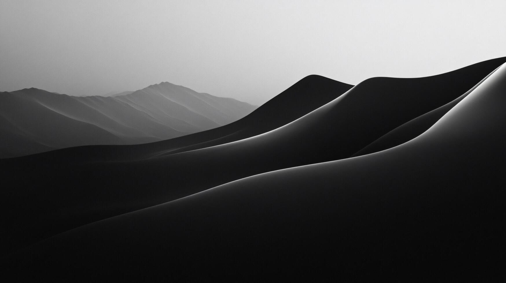 Smooth, black and white hills form an abstract landscape under a soft, light gray sky photo