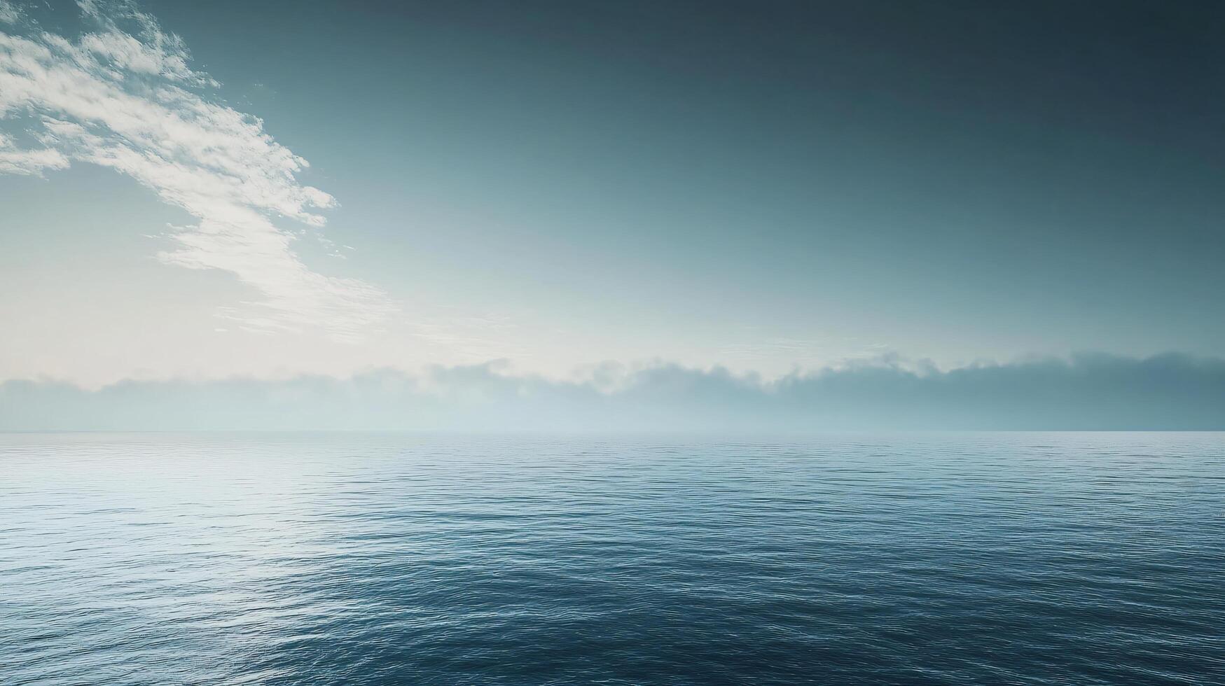 Serene seascape featuring calm ocean water, a misty horizon, and a cloudy sky during sunrise, creating a tranquil and atmospheric scene photo