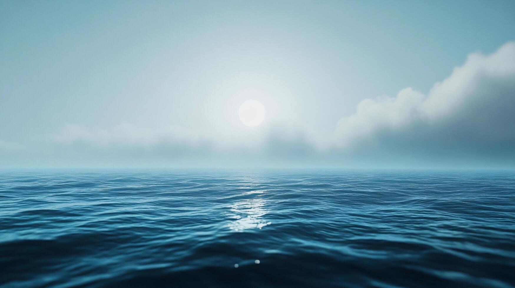 Calm ocean reflecting sunlight on a misty day with clouds photo