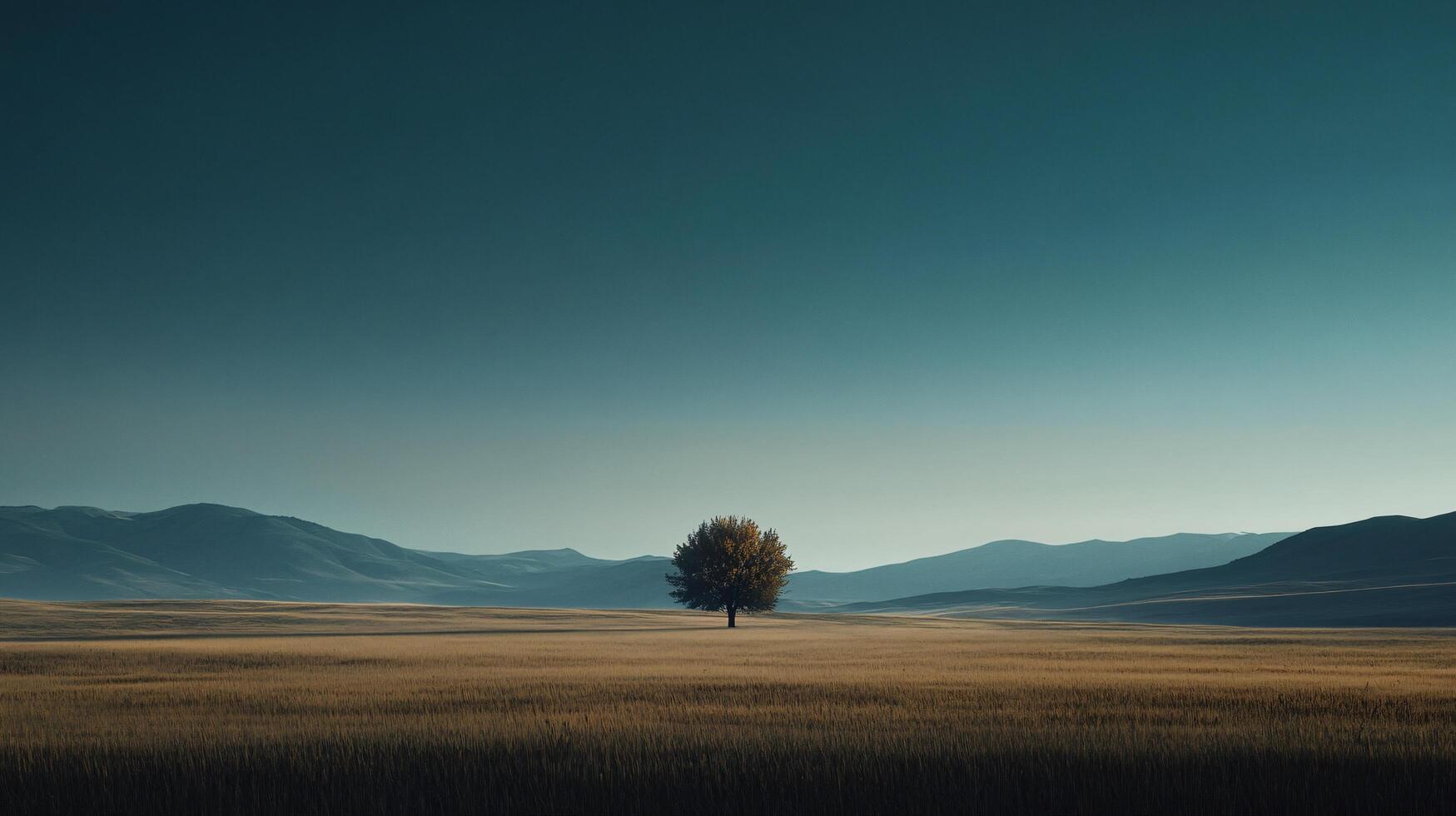 Scenic landscape featuring a solitary tree in a vast field, surrounded by majestic mountains under a teal colored sky photo