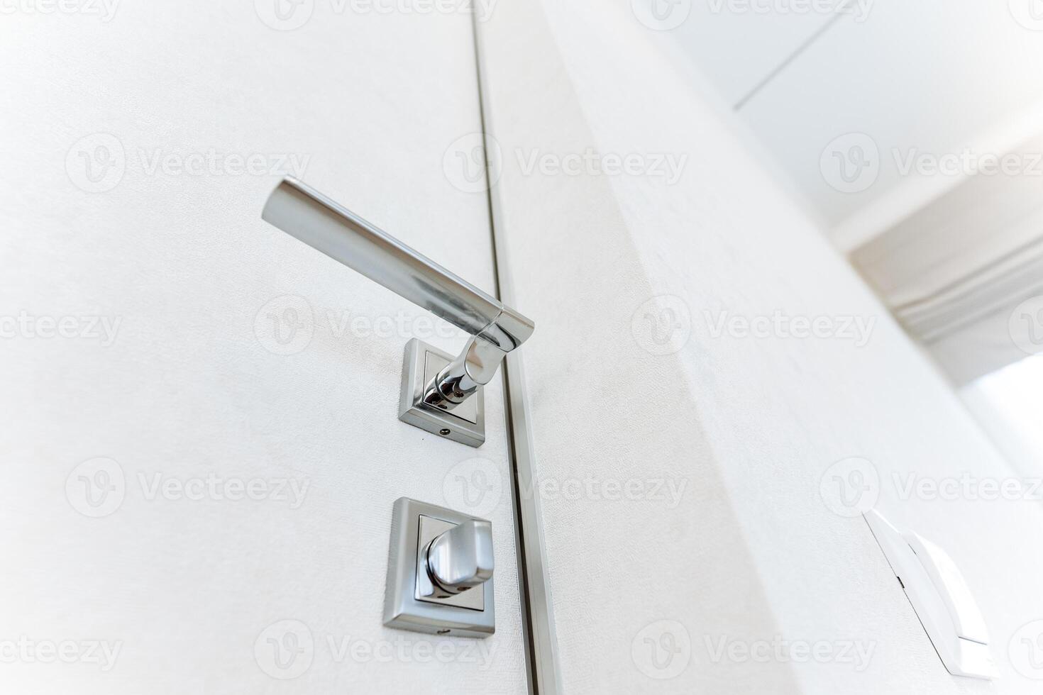 The stylish rectangular metal door handle, featured on a white door, combines automotive and fashion design, merging gadget aesthetics with a touch of style for a unique look photo