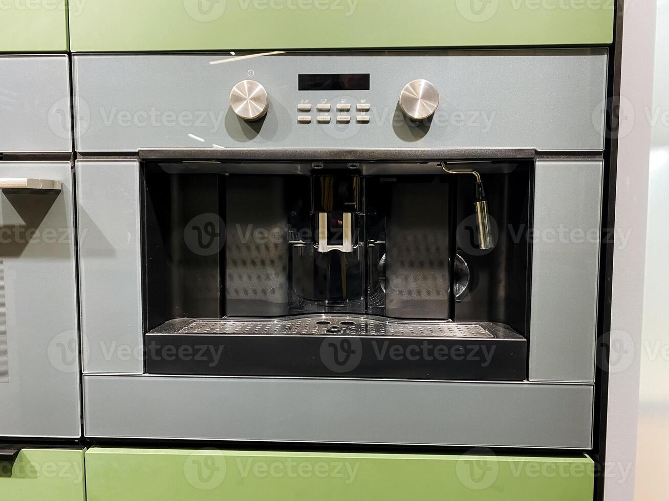A coffee maker is conveniently built into the wall of a modern kitchen for easy access and a streamlined appearance, making it an essential kitchen appliance for coffee enthusiasts photo
