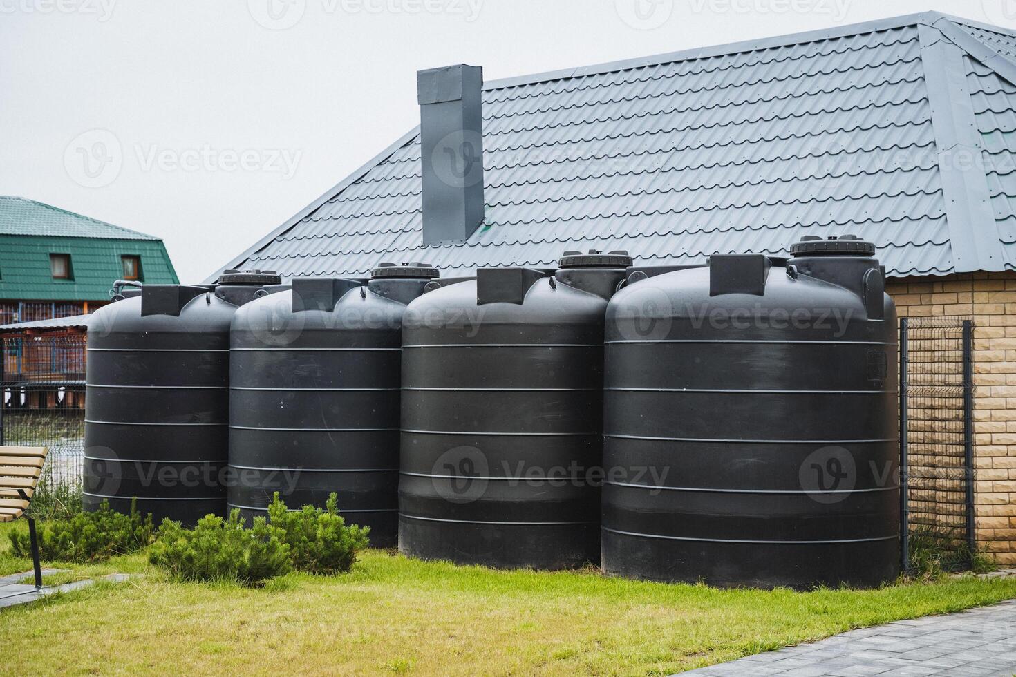 Next to the apartment complex, there are large black water tanks that store and supply water for the residents daily needs, ensuring a reliable water source on site photo
