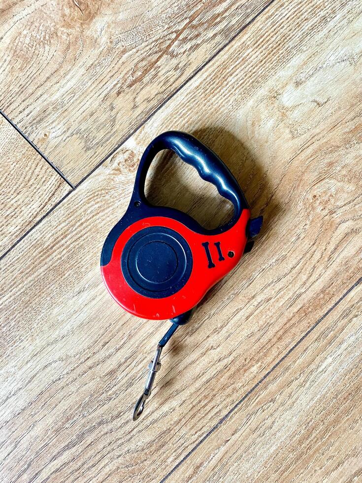 A striking red and black dog leash that has the number 11 printed on it photo