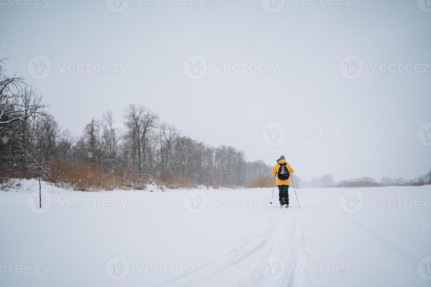 A person is engaging in the invigorating activity of cross country skiing on a snowy landscape, enjoying the beauty of winter and the thrill of outdoor recreation in the cold weather photo