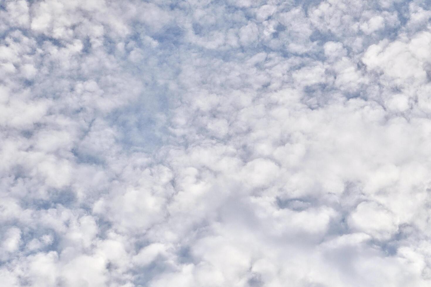 Fluffy white clouds texture on blue sky isolated on horizontal full frame background. photo