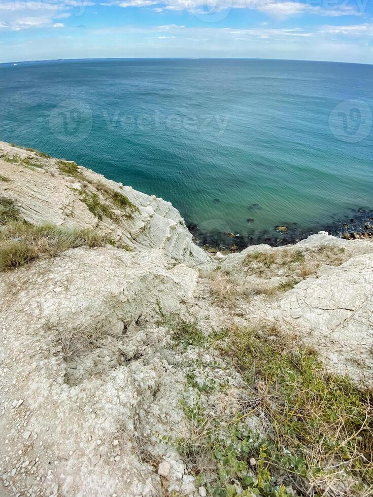 A stunning cliff that beautifully overlooks the vast ocean on a bright and sunny day, capturing the essence of coastal beauty and natural landscapes that mesmerize everyone photo