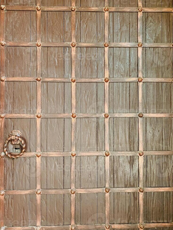 Here is a detailed closeup view of a beautiful wooden door that features intricate and elegant copper trim, showcasing the exquisite craftsmanship involved in its design photo