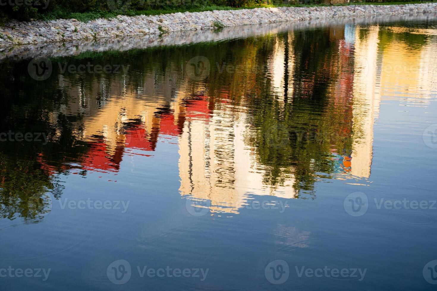 An artistic reflection of a modern building is beautifully mirrored in a tranquil body of water, creating a stunning visual experience that highlights natures serene landscape photo