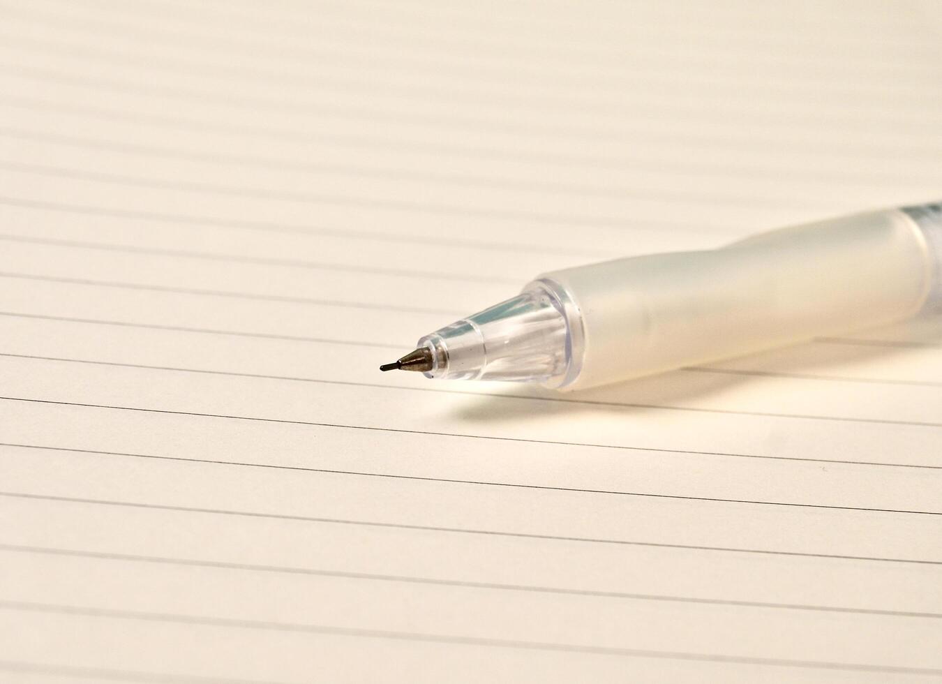 Close up note book with white lined paper and sharp mechanical pencil lead isolated on horizontal background. photo