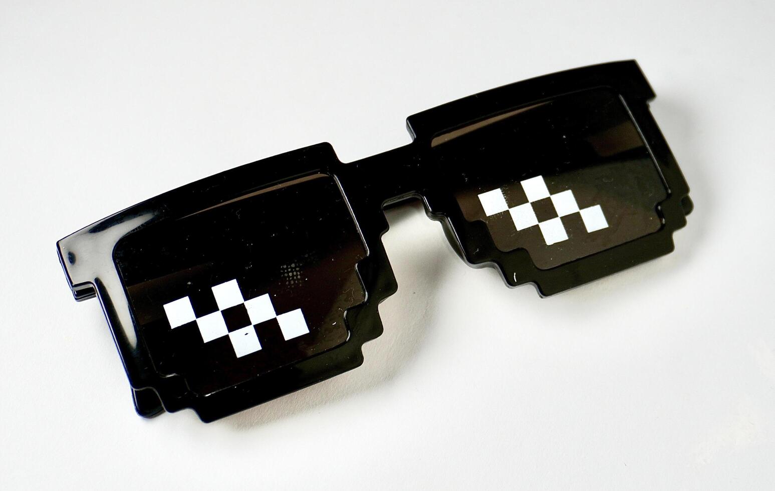 Funny pixel styled sunglasses eyewear isolated on horizontal white background. photo