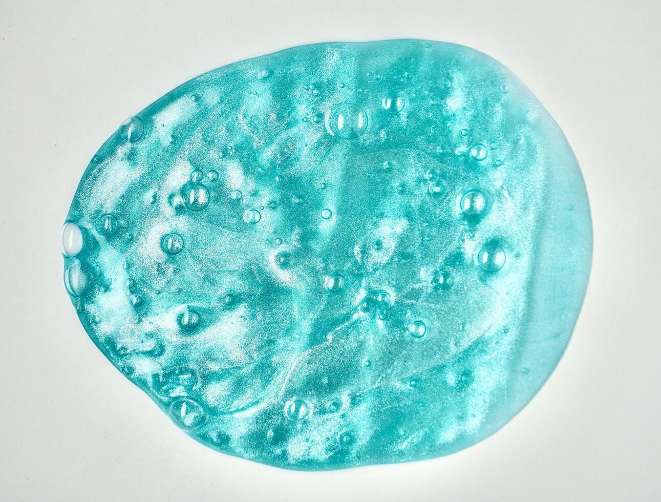 Blue stretchy slime toy object with bubbles texture isolated on horizontal white background. photo
