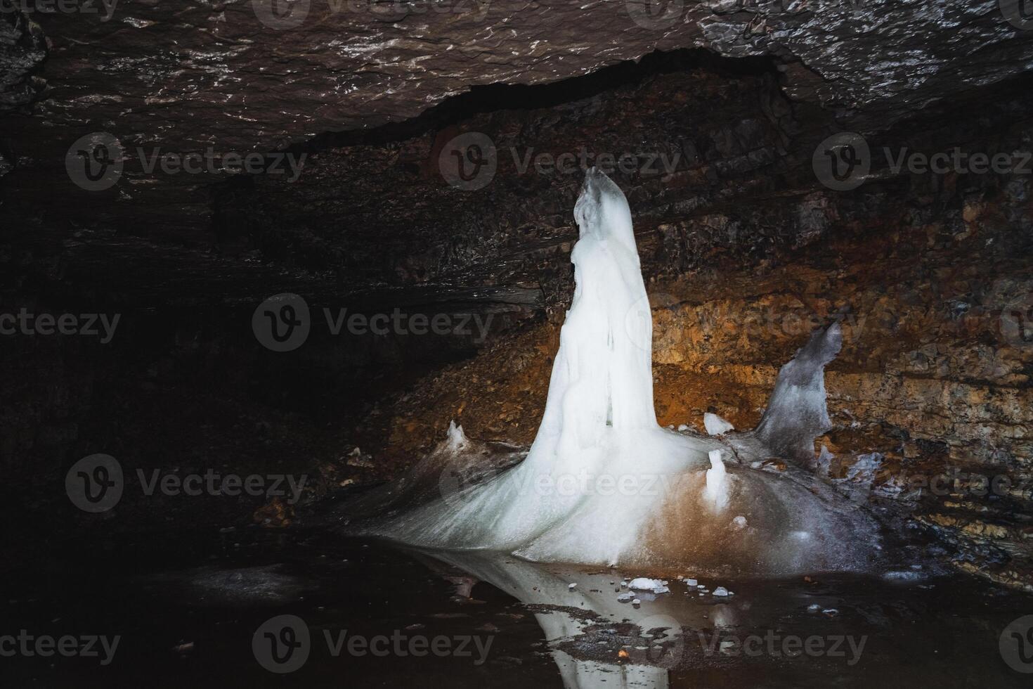 Experience the breathtaking beauty of a majestic ice formation found within a stunning underground cave setting, perfect for adventure seekers photo