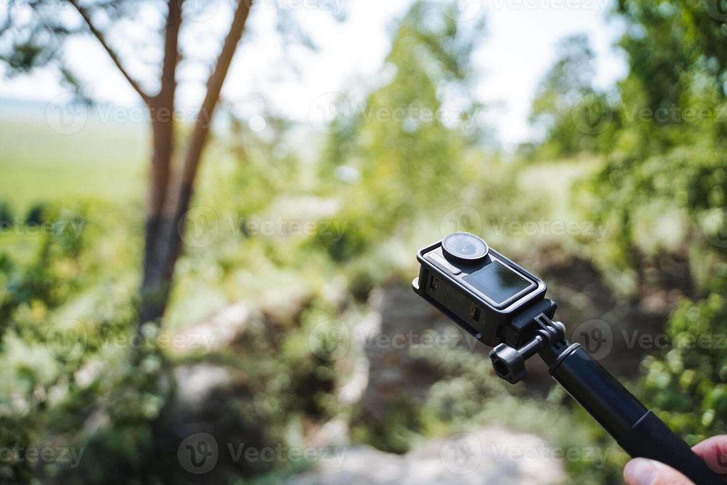 Make your outdoor experiences unforgettable by using an action camera on a selfie stick to capture the breathtaking beauty of nature during your adventures and explorations photo