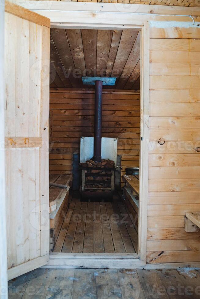 A beautifully crafted wooden sauna featuring a traditional stove creates a wonderfully warm and inviting atmosphere that is truly ideal for relaxation after a long and tiring day photo