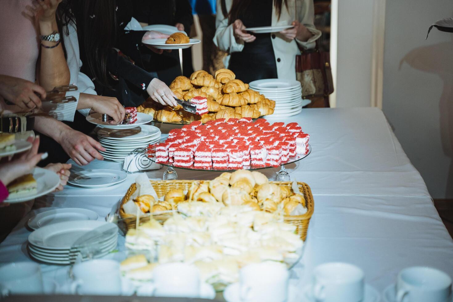 People gathered around a table sharing food at a social event photo
