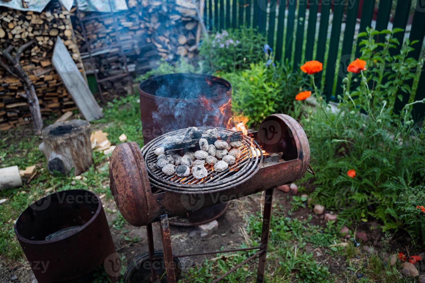 Set in a peaceful backyard, a barbecue grill blends seamlessly with the rich green grass, forming a calm outdoor cooking area that harmonizes with the natural surroundings photo
