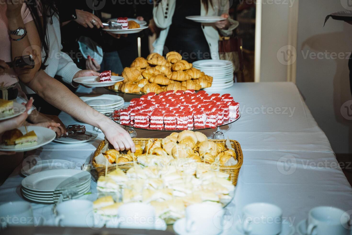 People gathered around a table with a variety of food for sharing photo