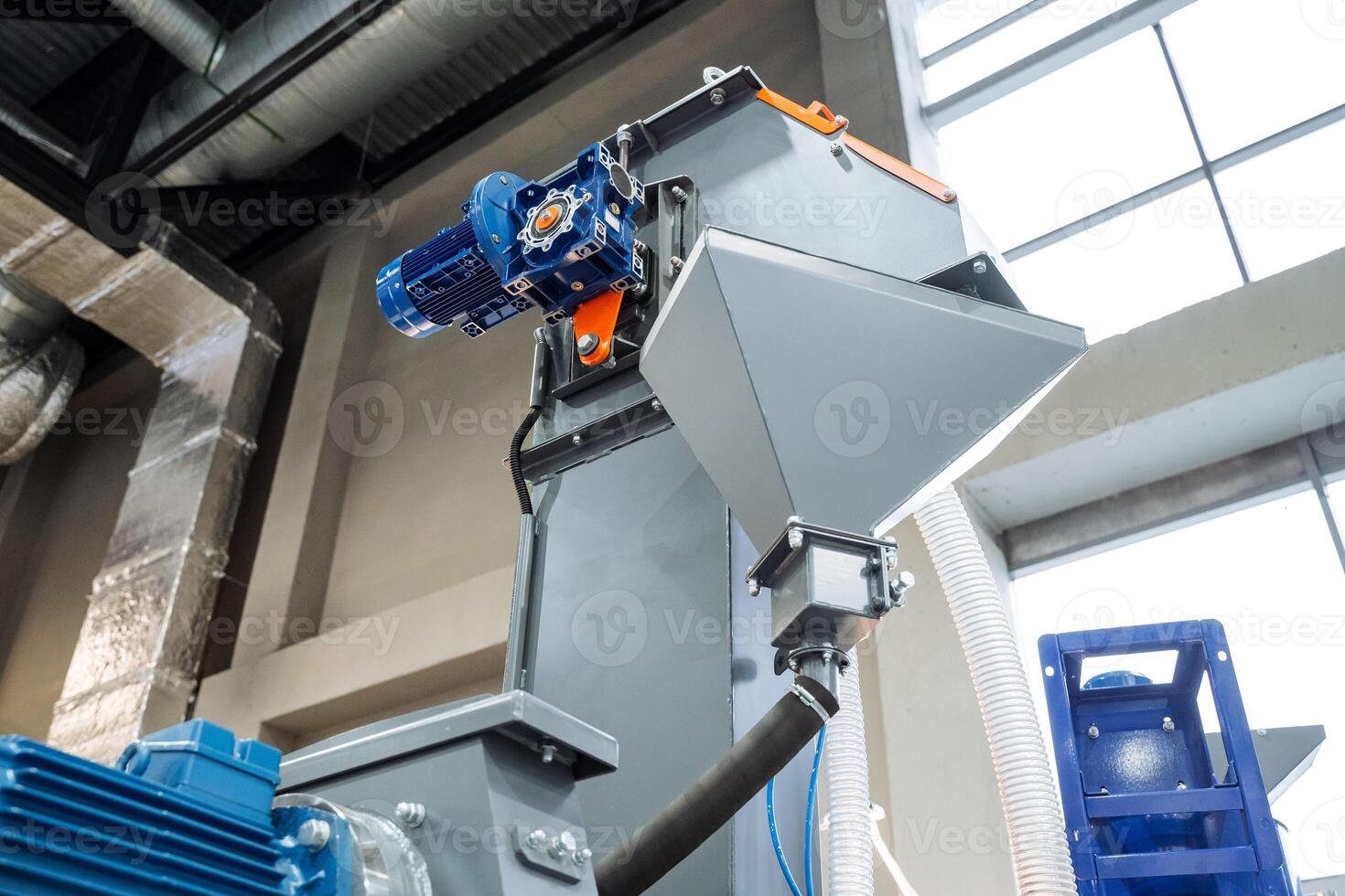 Industrial machinery equipped with an electric motor plays a crucial role in material processing within a contemporary factory environment photo