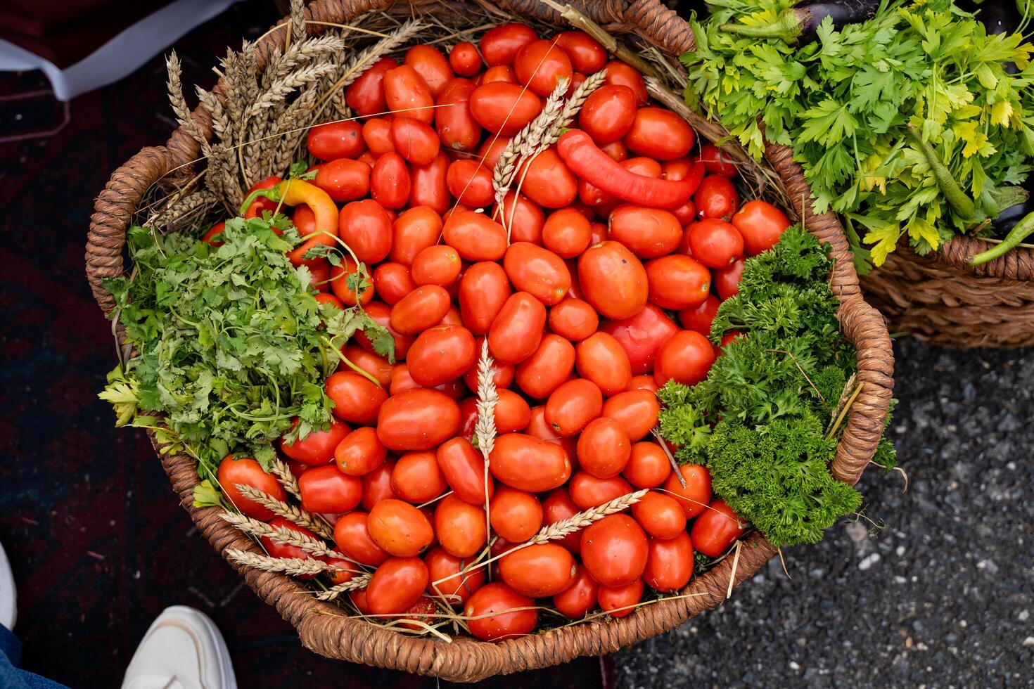 A beautiful and vibrant basket overflowing with ripe, juicy tomatoes and an array of fresh, colorful vegetables, showcasing the wonderful bounty of natures harvest from a local greengrocer photo