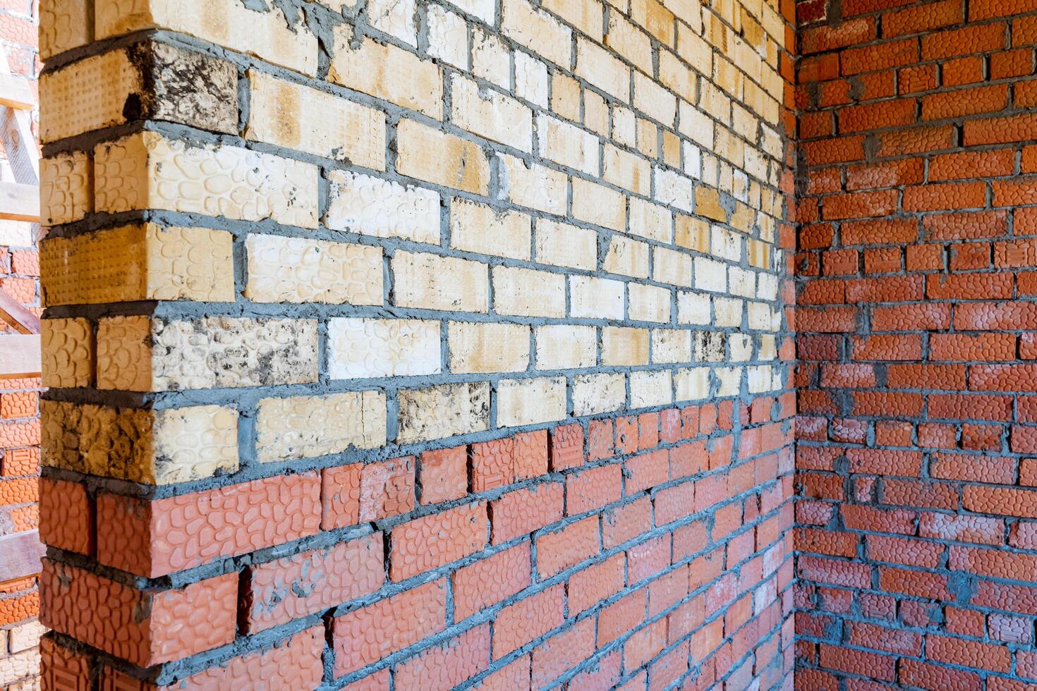 Conducting a thorough examination of a brick wall on a construction site, emphasizing its construction, durability, and architectural characteristics like materials and designs photo