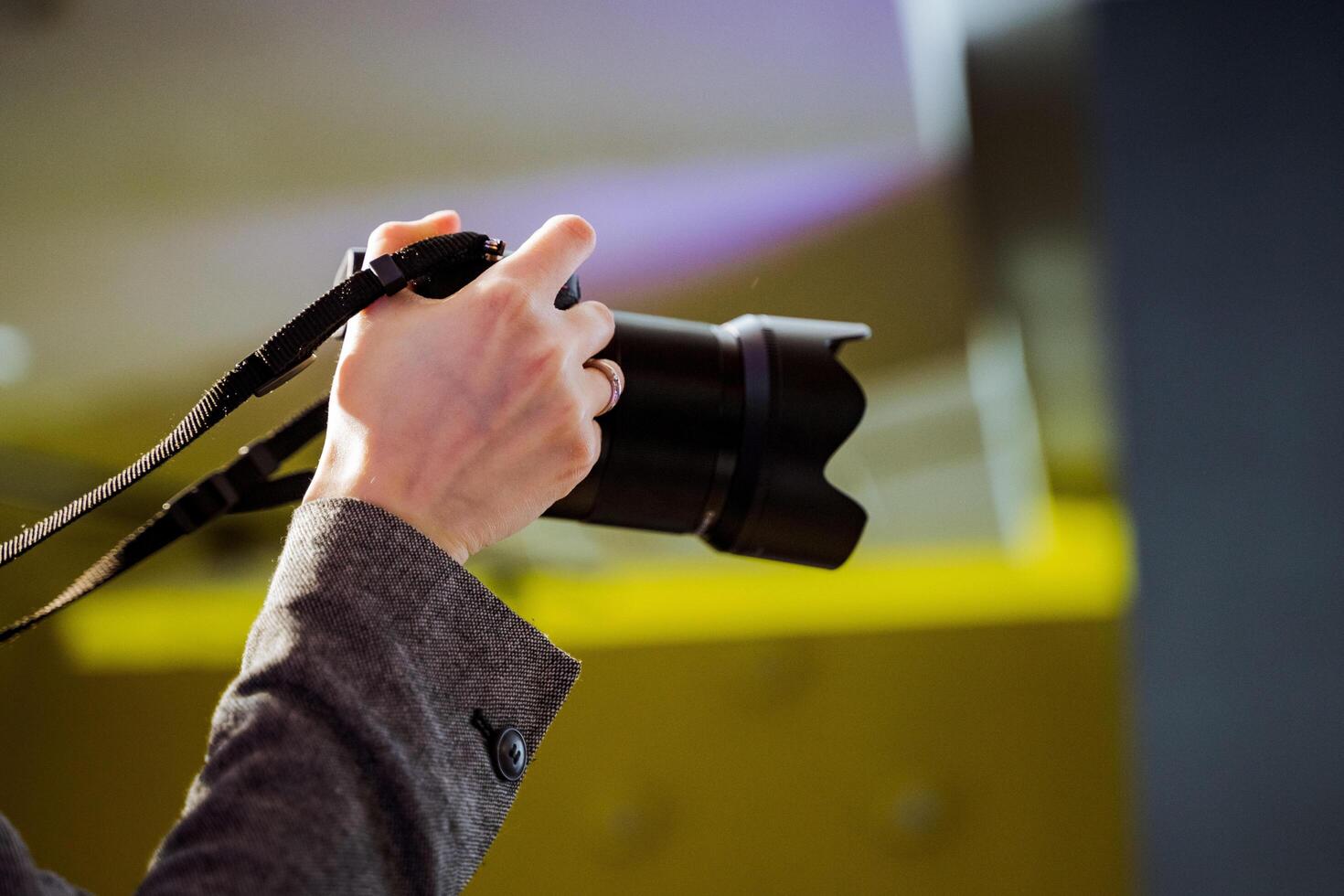 Person capturing moment with camera at automotive event photo