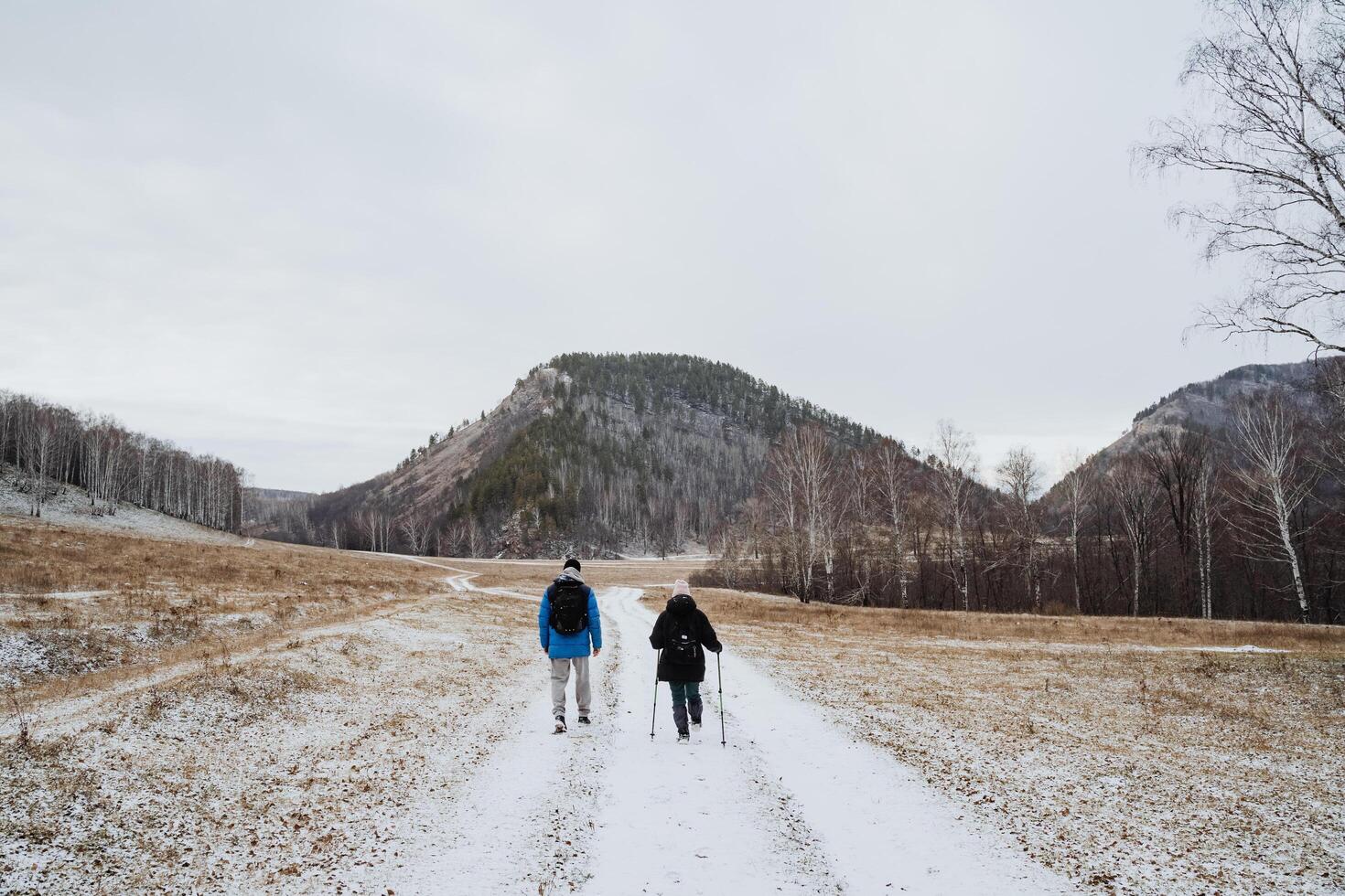 Winter Hike Adventure Two Friends Warmly Embrace and Appreciate the Chilly Beauty of Nature While Exploring the Stunning and Serene Snowy Trails photo