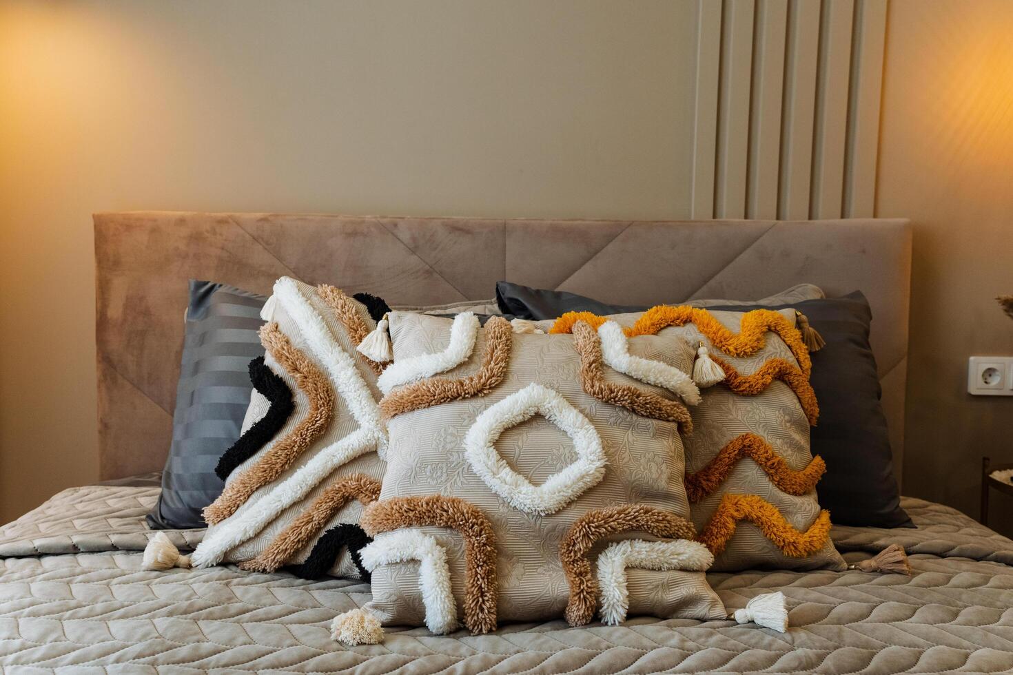 In a warm and cozy bedroom, there exists a sumptuous bed adorned with soft, fluffy pillows that create a plush atmosphere perfect for achieving ultimate relaxation and restful sleep photo