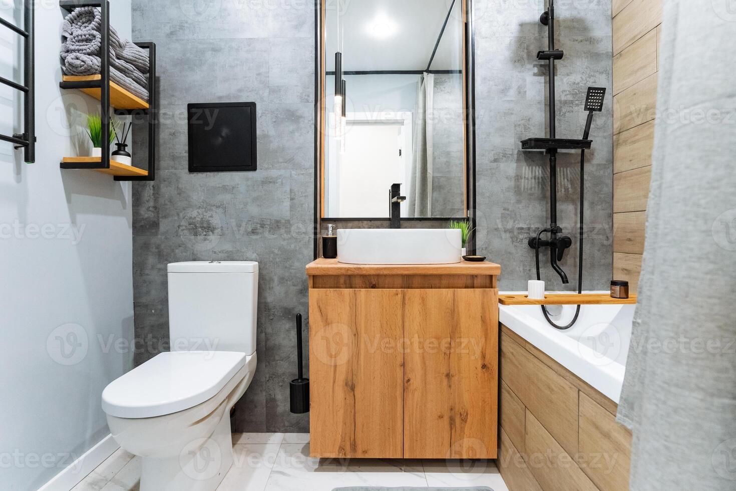 The bathroom is an essential part of any home, equipped with a toilet for waste disposal, a sink for hygiene purposes, and a bathtub for both relaxation and thorough cleaning practices photo