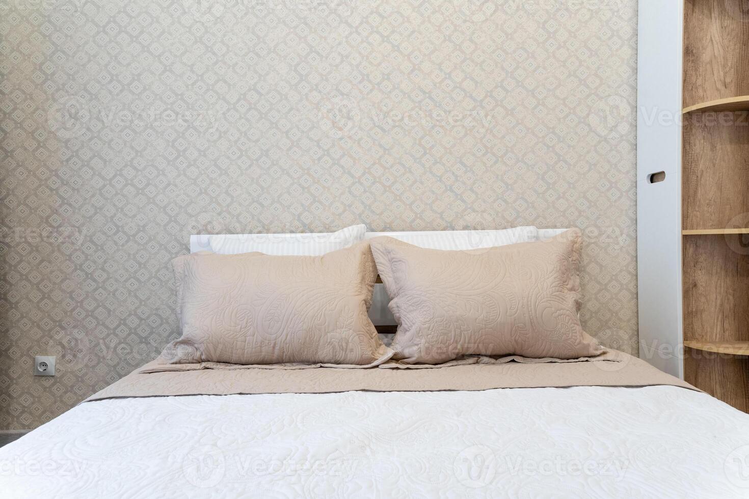 The incredibly cozy and inviting bedroom features a comfortable bed adorned with two soft, fluffy pillows, creating an ideal space for restful sleep and ultimate relaxation photo