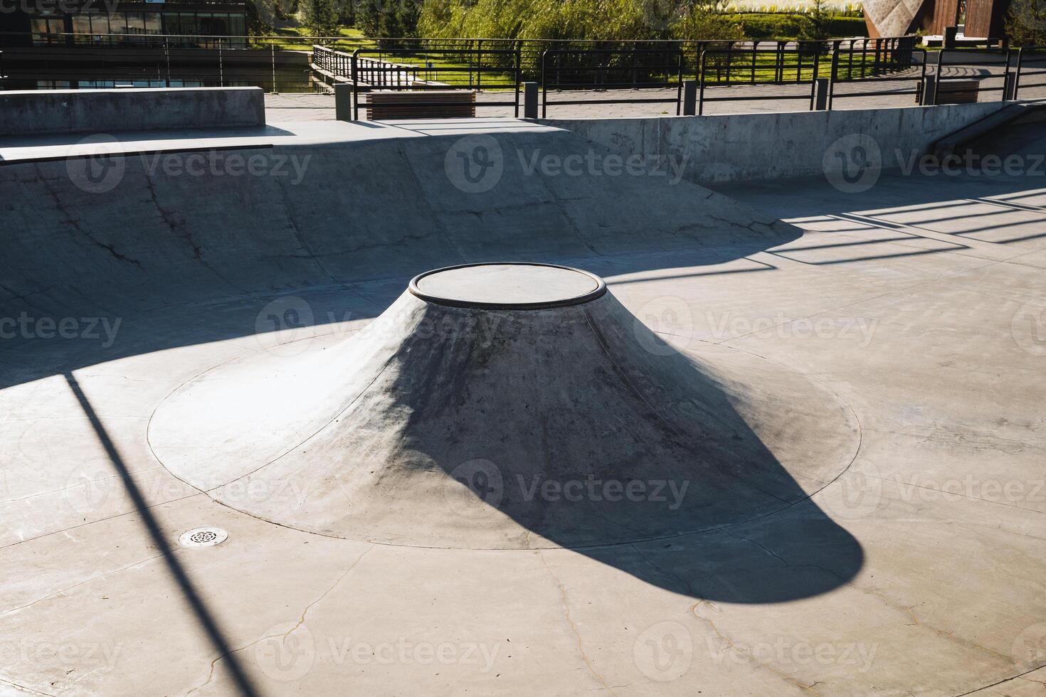 A skilled skateboarder is enthusiastically riding down a steep ramp at a vibrant skate park, showcasing their talent and enjoying the thrill of the ride in an exciting urban environment photo