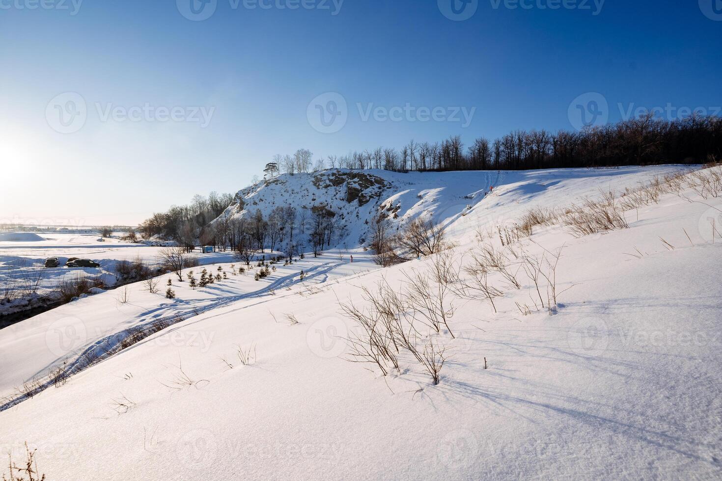 Frosty day, beautiful landscape in winter, forest on the mountain, blue sky. photo