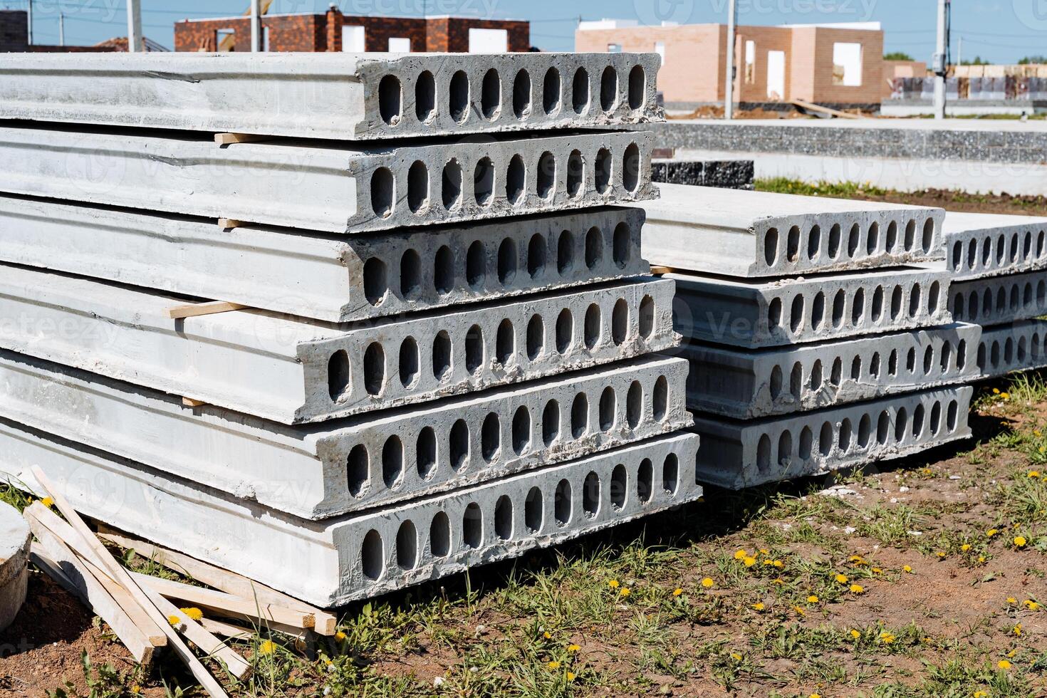 A stack of concrete slabs arranged atop each other at a construction site, enhanced by urban design elements and landscaping features, showcasing a fusion of modernity and functionality photo