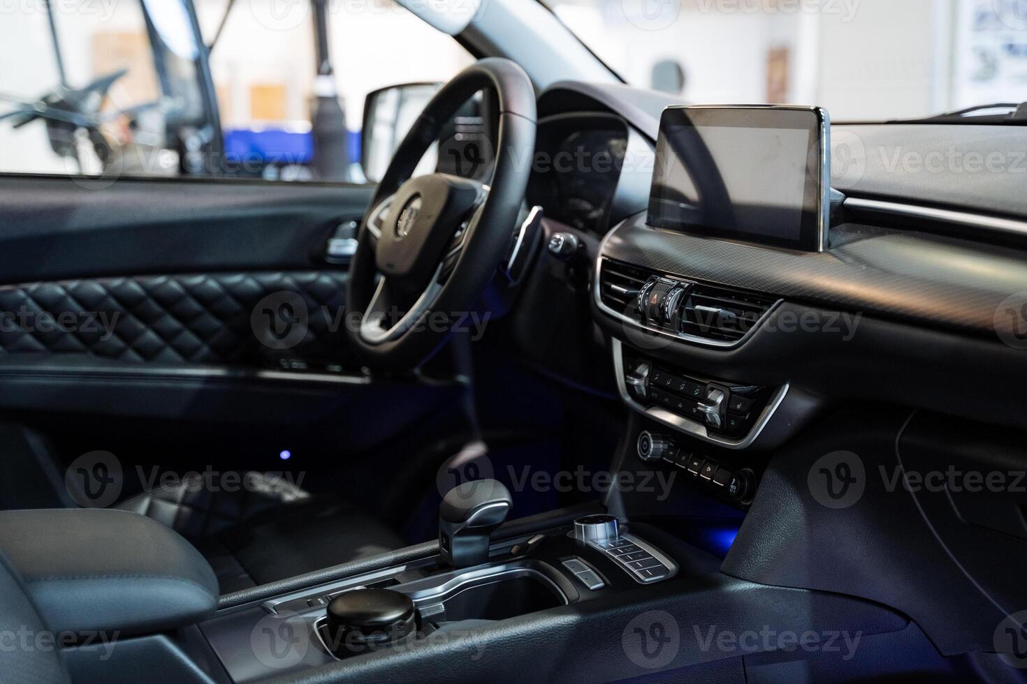 The interior of a modern car features a sleek tablet prominently displayed on the dashboard, enhancing the digital experience and connectivity for the driver and passengers photo