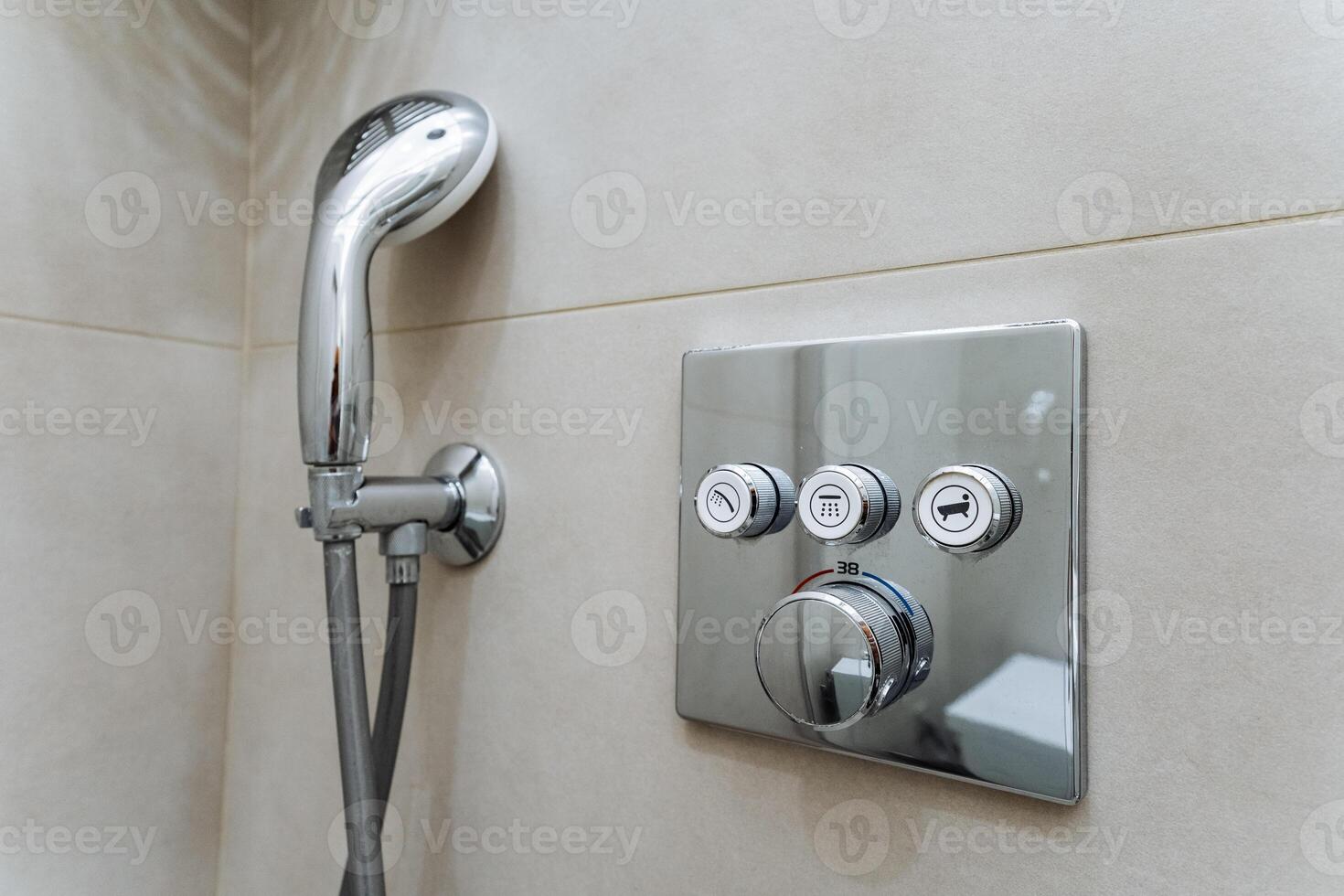 Revamp your bathroom by installing a modern shower system with a stylish handheld shower head chic chrome control panel for a contemporary luxurious appearance photo
