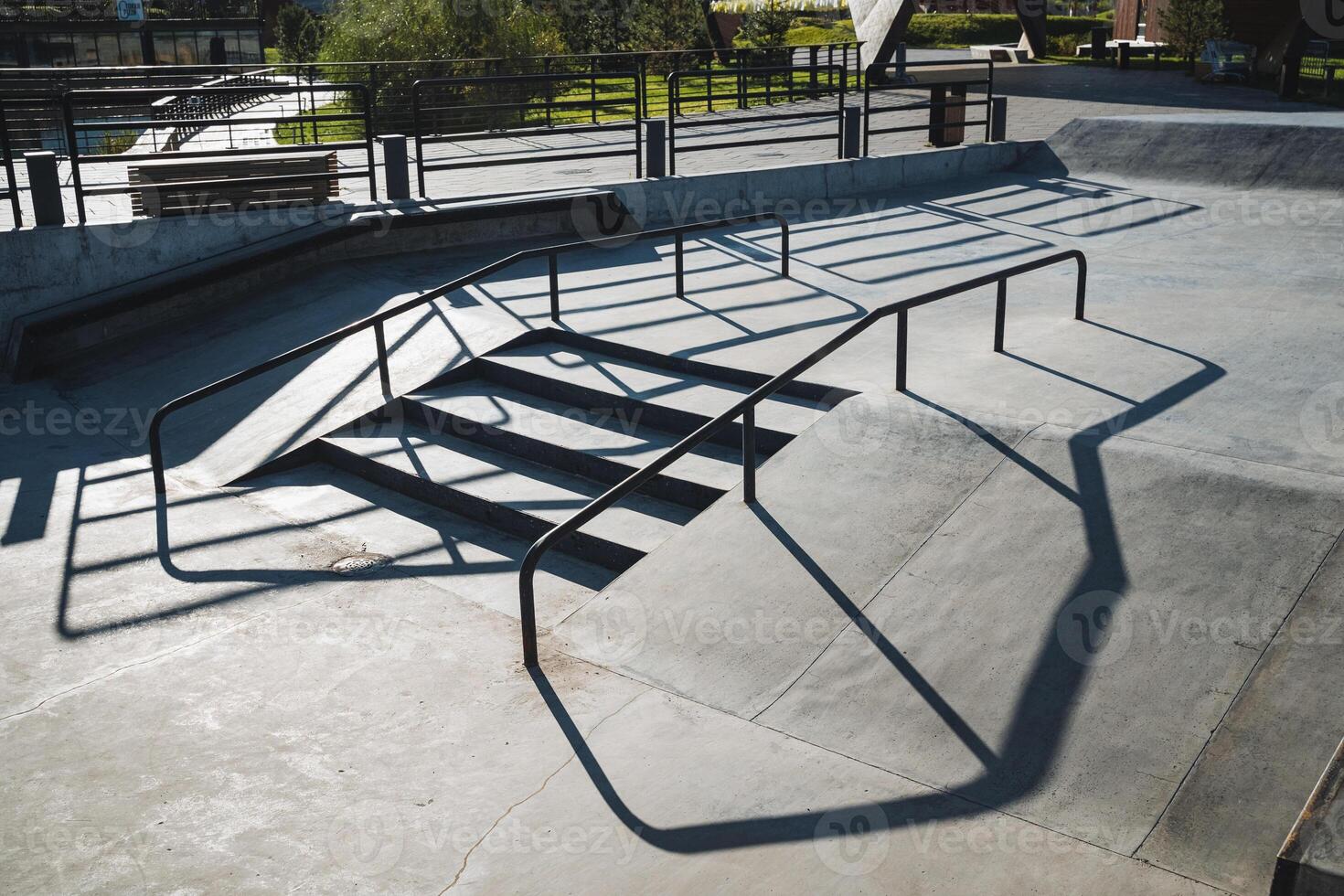 A distinct shadow of a beautifully designed staircase is cast upon a smooth and unblemished concrete surface, creating an intriguing visual contrast that enhances the urban environment photo