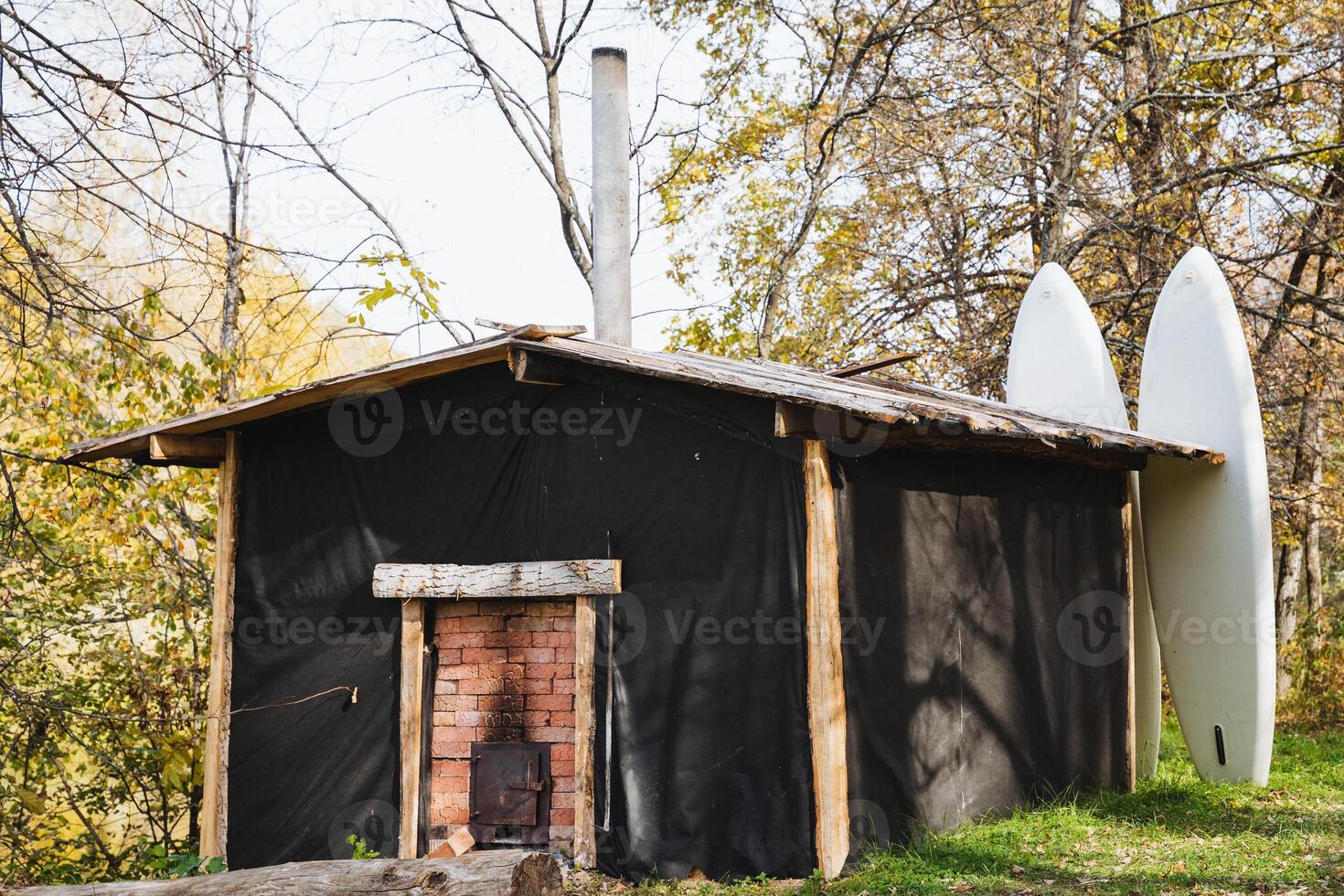 This charming and cozy house is enhanced by a warm and inviting fireplace, and it also showcases two surfboards, hinting at a laidback beach lifestyle and a deep passion for surfing photo