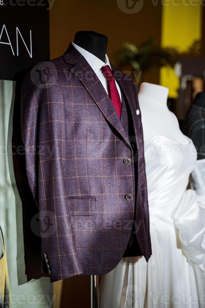 Mannequin in suit and tie stands next to mannequin in wedding dress photo