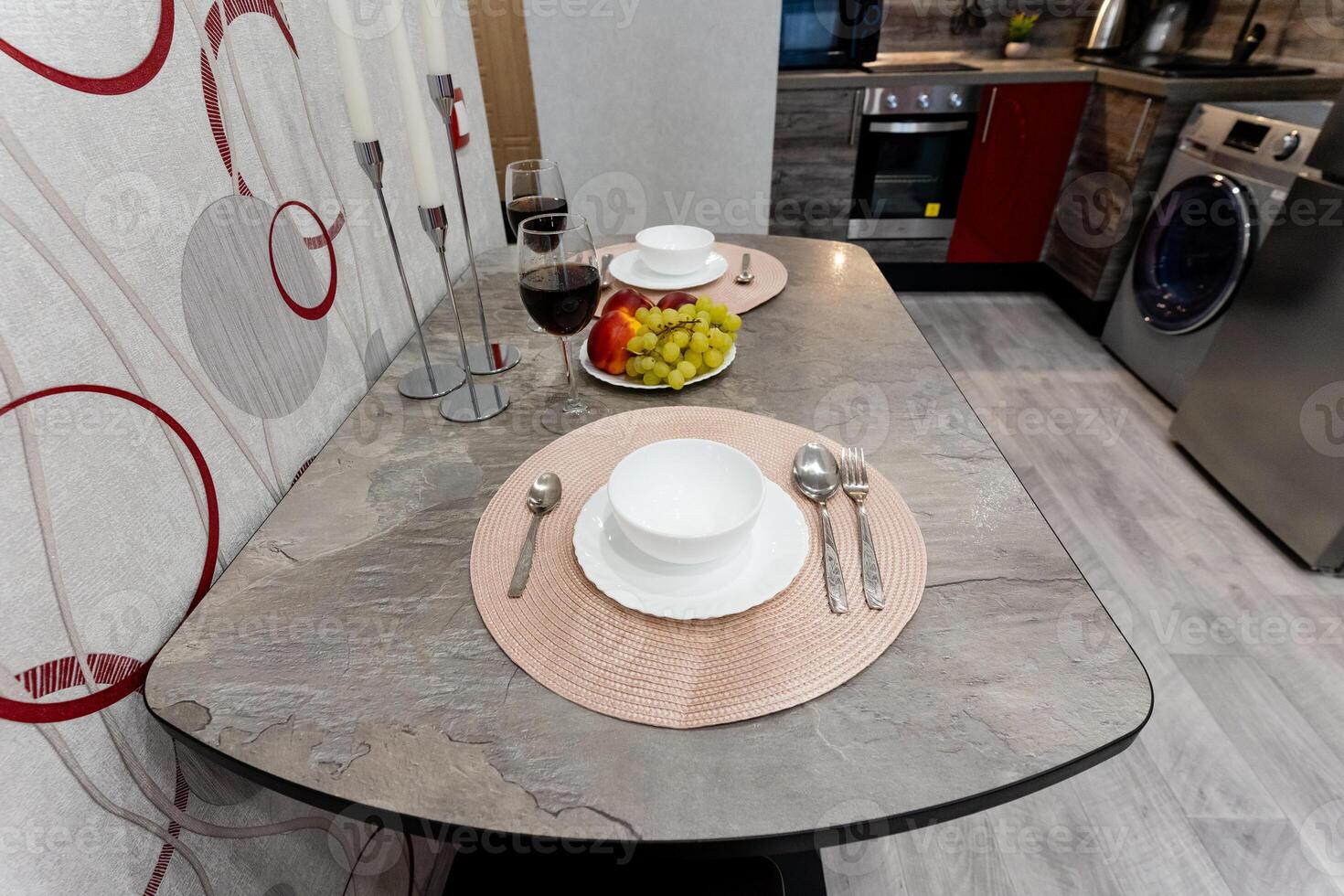 In a cozy kitchen, a carefully arranged table featuring plates and utensils helps to create a warm and inviting atmosphere that draws you in, making you feel right at home and relaxed photo