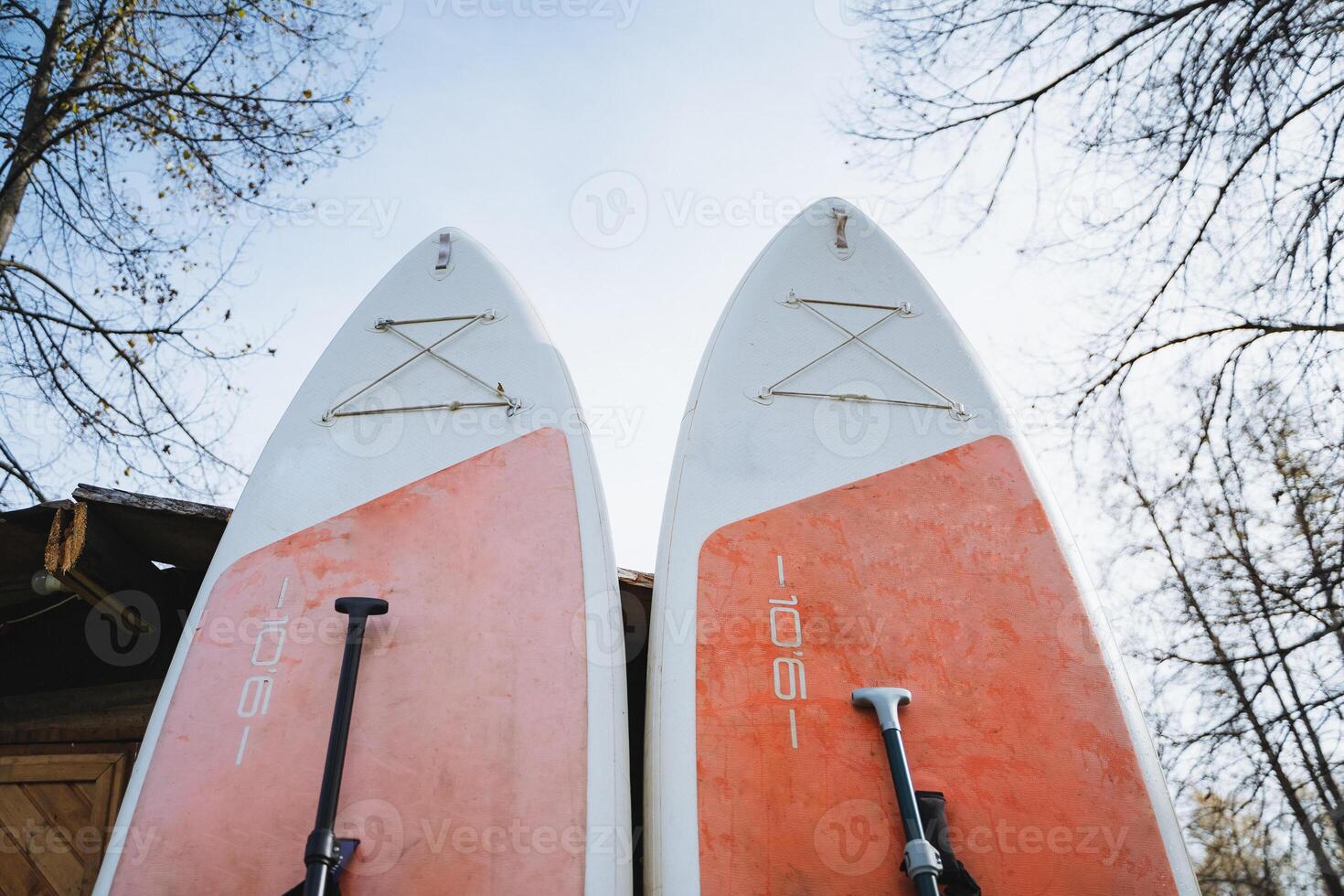 Two exquisitely decorated surfboards, both adorned with the letter k, eagerly await a thrilling day filled with adventure and enjoyment as they are ready to take on the waves ahead photo