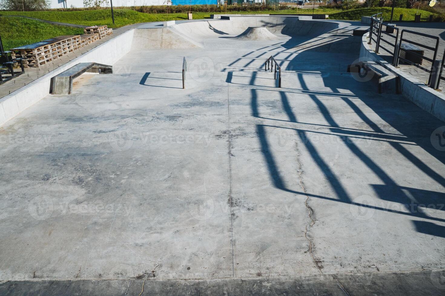 This impressive concrete skate park features unique shadows, making it an ideal spot for skate enthusiasts to demonstrate their exceptional skills in a lively and vibrant urban environment photo