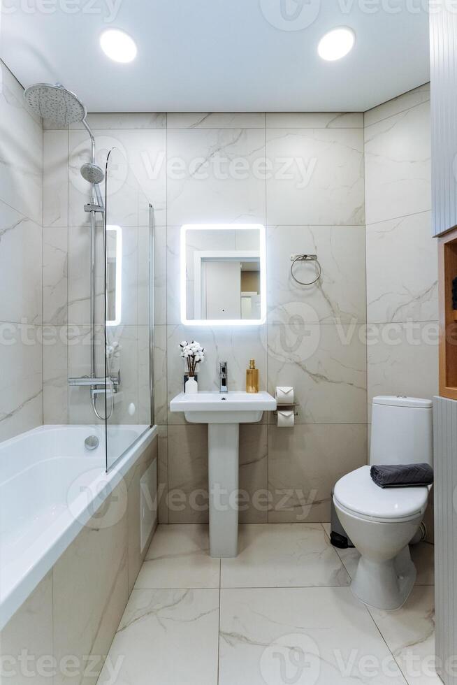 Imagine a bathroom that is equipped with essential amenities including a sink, a toilet, a bathtub, and a mirror, creating a fully functional and comfortable space for daily routines photo