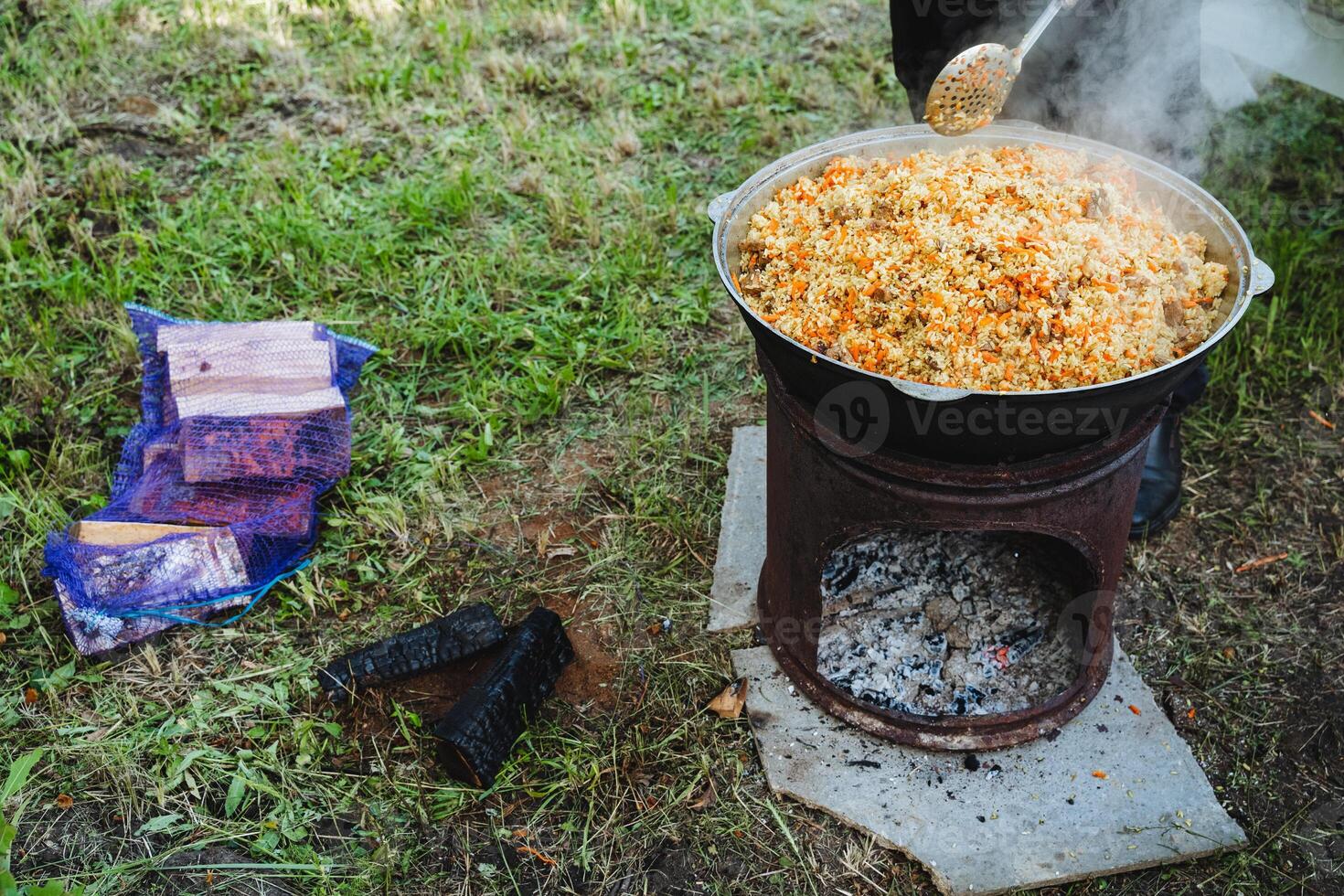 In a kitchen, a person is shown adding rice into a pot on a stove for cooking. This image showcases food preparation in a home environment, emphasizing the process of cooking photo
