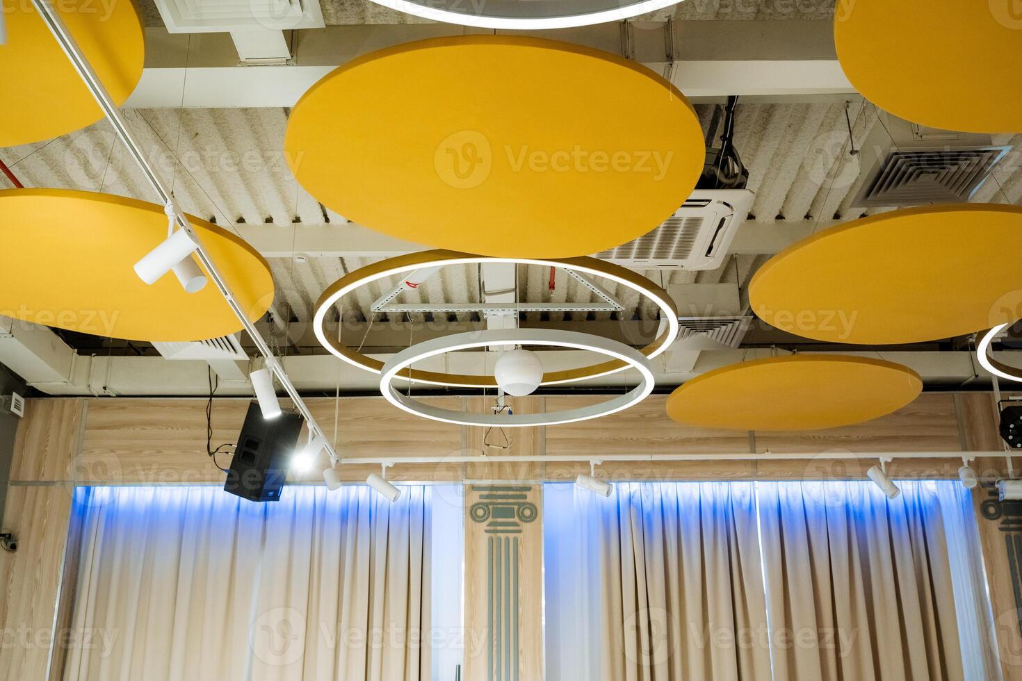 Beautiful banquet hall interior, ceiling lighting, round llama on the ceiling, LED lamp. photo