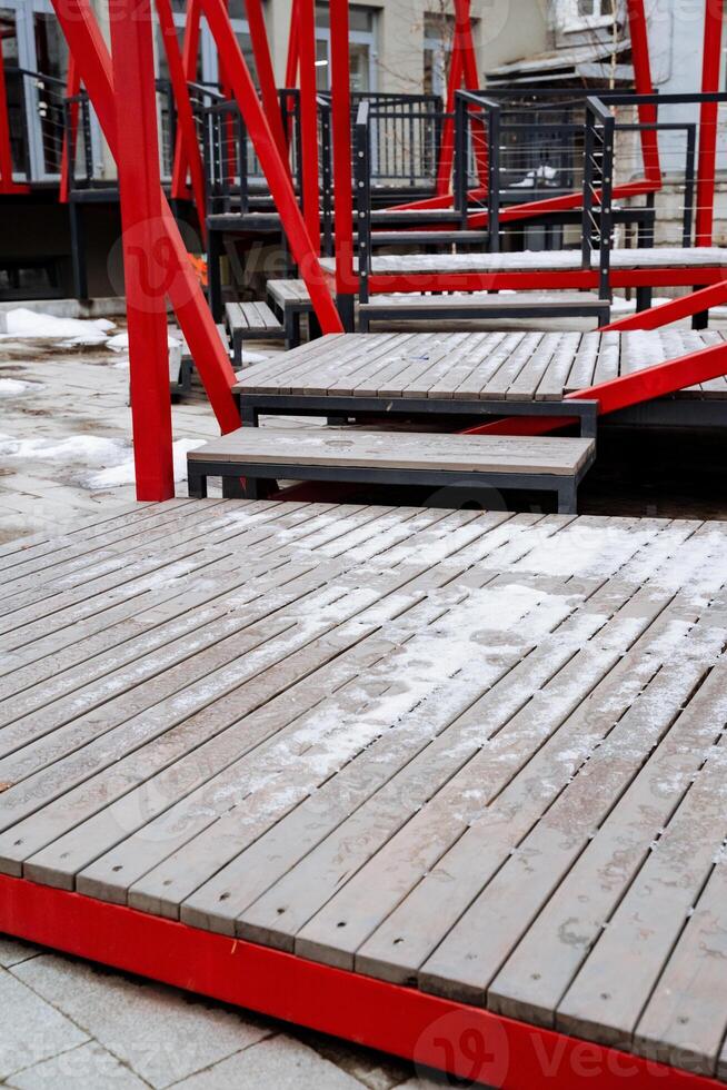 A beautifully designed wooden deck with vibrant red railings and elegant stairs enhances the outdoor area, ideal for relaxation and creating cherished memories with family and friends photo