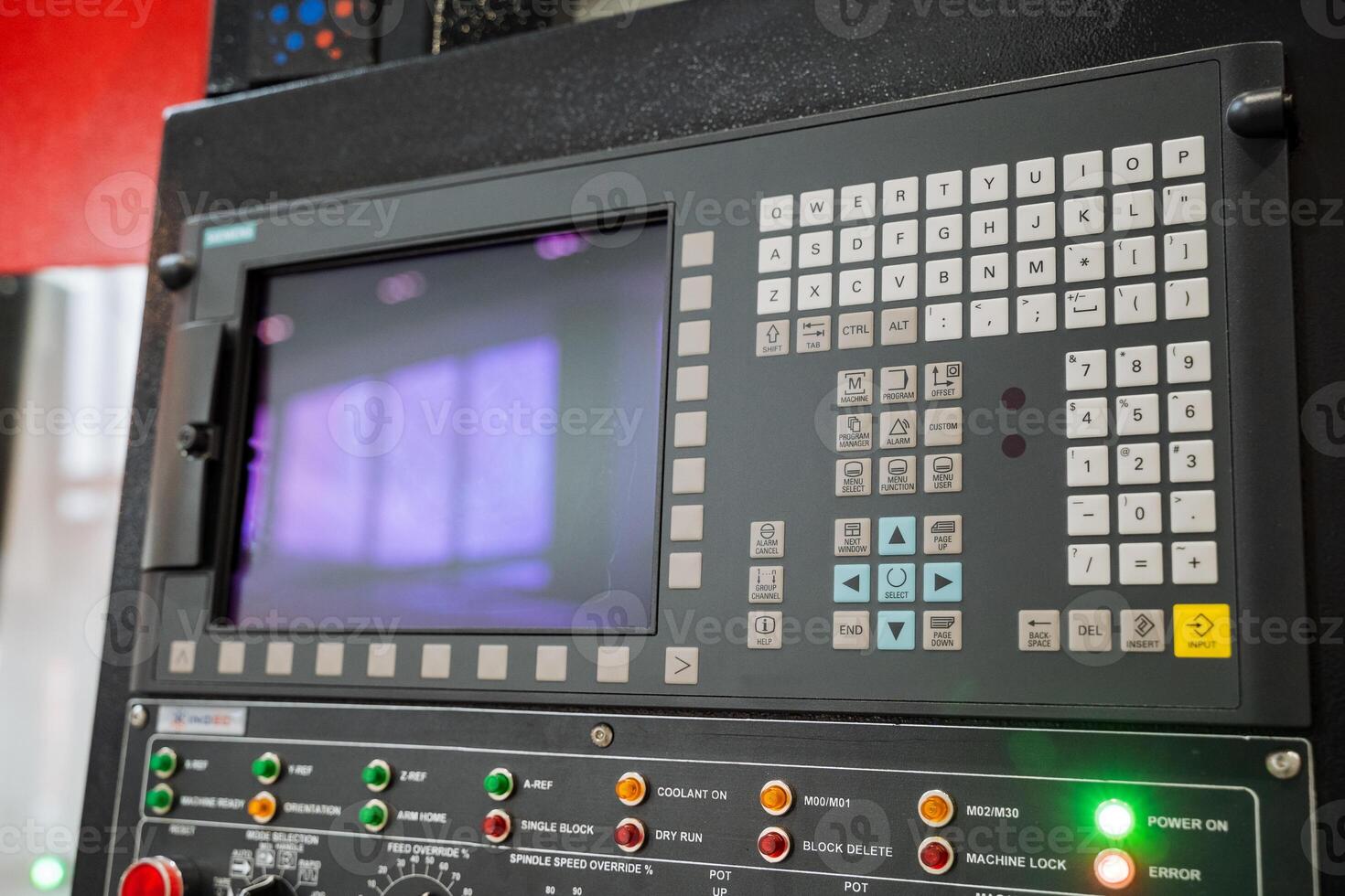 This is a detailed closeup view of a sophisticated machine control panel that features various buttons and a digital screen, showcasing its advanced functionalities and technology photo