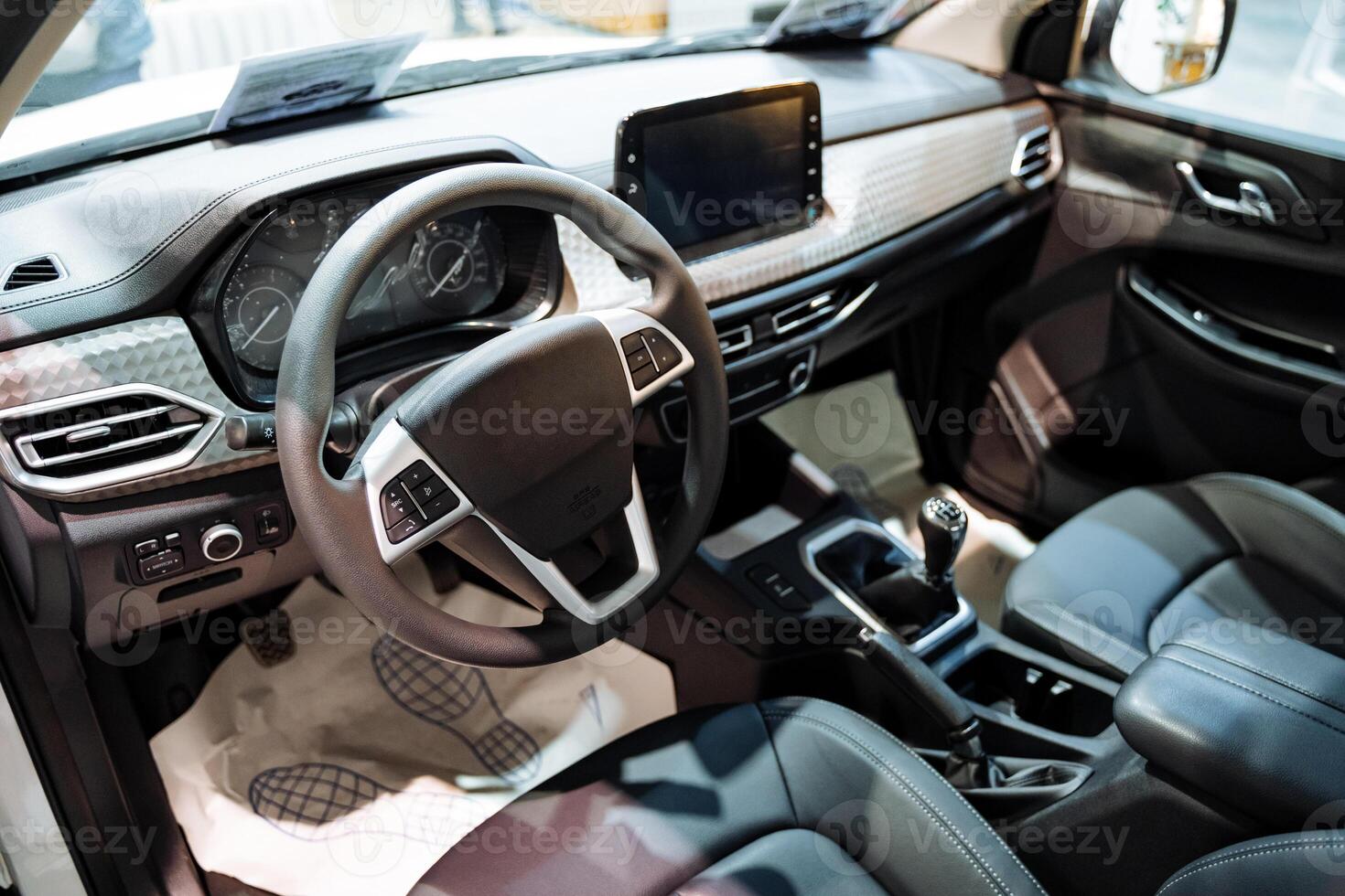 The interior of a modern automobile features a steering wheel along with comfortable seats, providing essential components for the functionality and familiarity of the driving experience photo